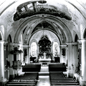 Inneres der Pfarrkirche zum hl. Laurentius, Wörgl vor der Umgestaltung 1961. Beim Hochaltar sind jene Kirchenfenster noch ersichtlich, welche sich seit der Umgestaltung links und rechts der Orgelempore befinden.