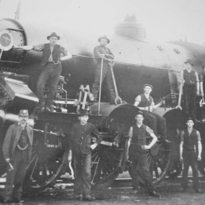 1905, Lokführer Unterguggenberger mit dem großen Schraubenschlüssel, 2 v.l. oben auf der Schnellzug-Dampflokomotive der kkStB-Reihe 110.