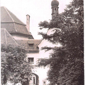 Ansicht der Friedhofskapelle mit Pfarrhof (ehem. Friedhof) nach der Kirchenerweiterung 1912. 1962 wurde sie zur Taufkapelle umgestaltet.