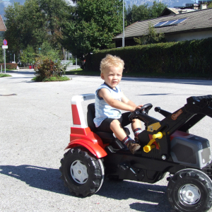 2011, kleiner Traktorfahrer vor dem Auhäusl und dem Weißkopf-Haus